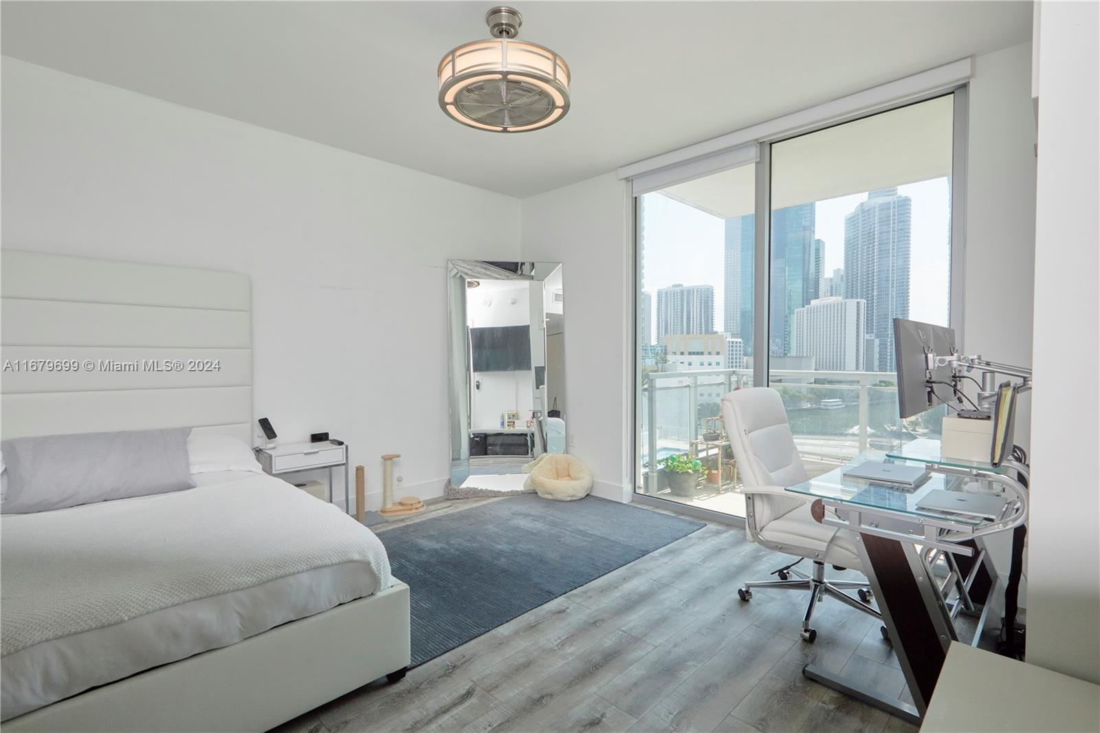 92 Southwest 3rd Street, Unit 1211 Miami, FL 33130 - Photo 8 of 17 a bedroom with a bed and a table