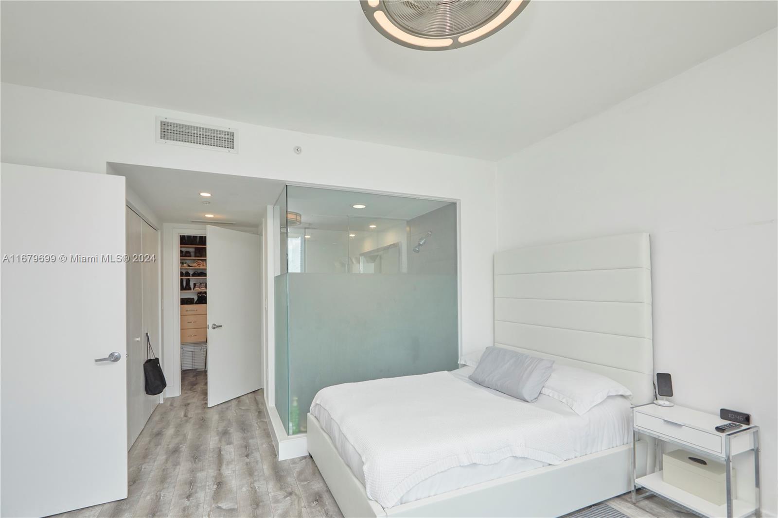 92 Southwest 3rd Street, Unit 1211 Miami, FL 33130 - Photo 10 of 17 a bedroom with a bed and a table