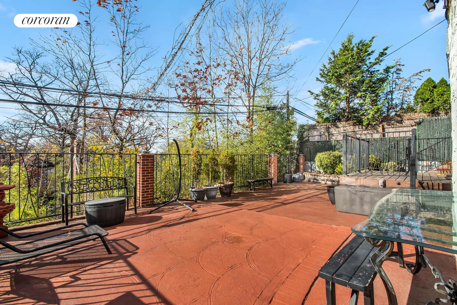 81-22 Haddon Street Queens, NY 11432 - Photo 12 of 13 a backyard of a house with barbeque oven table and chairs