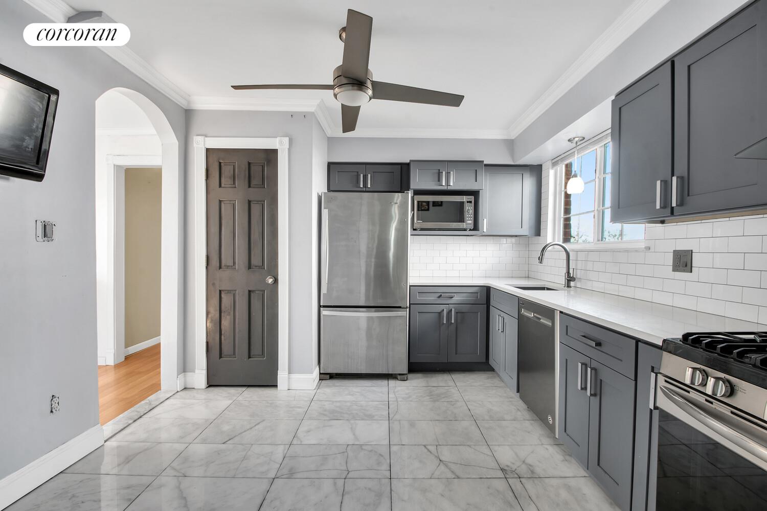 81-22 Haddon Street Queens, NY 11432 - Photo 2 of 13 a kitchen with stainless steel appliances granite countertop a refrigerator and a sink