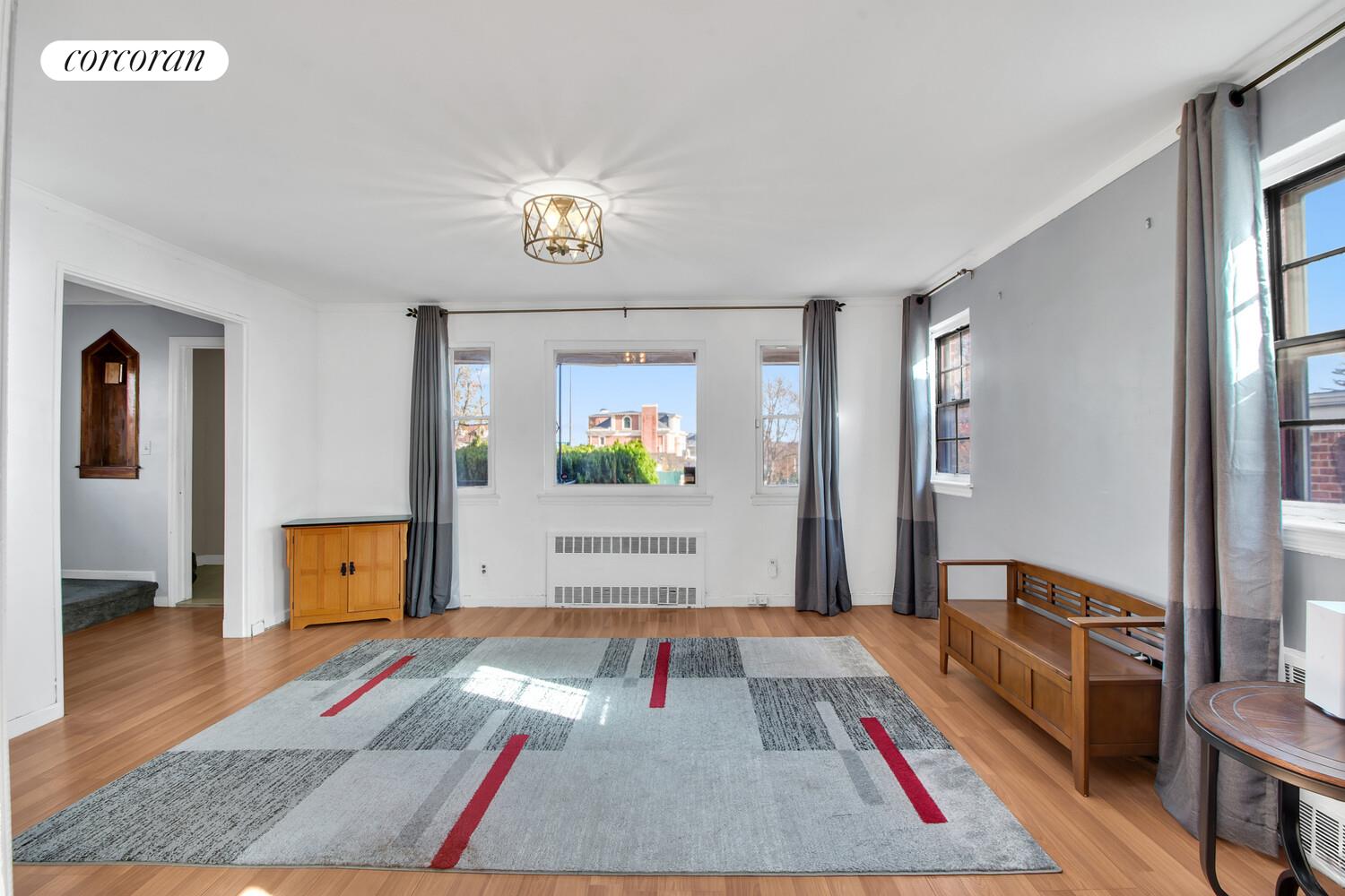 81-22 Haddon Street Queens, NY 11432 - Photo 3 of 13 a living room with furniture and a wooden floor