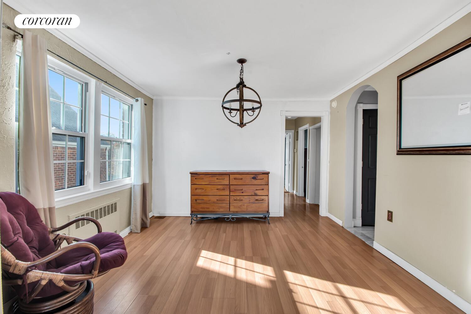 81-22 Haddon Street Queens, NY 11432 - Photo 6 of 13 a room with wooden floor and windows