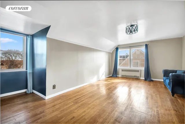 a room with wooden floor and windows