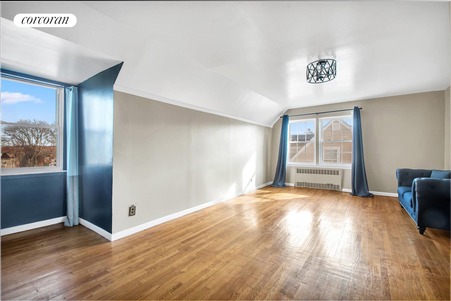 81-22 Haddon Street Queens, NY 11432 - Photo 7 of 13 a view of an empty room with window and wooden floor