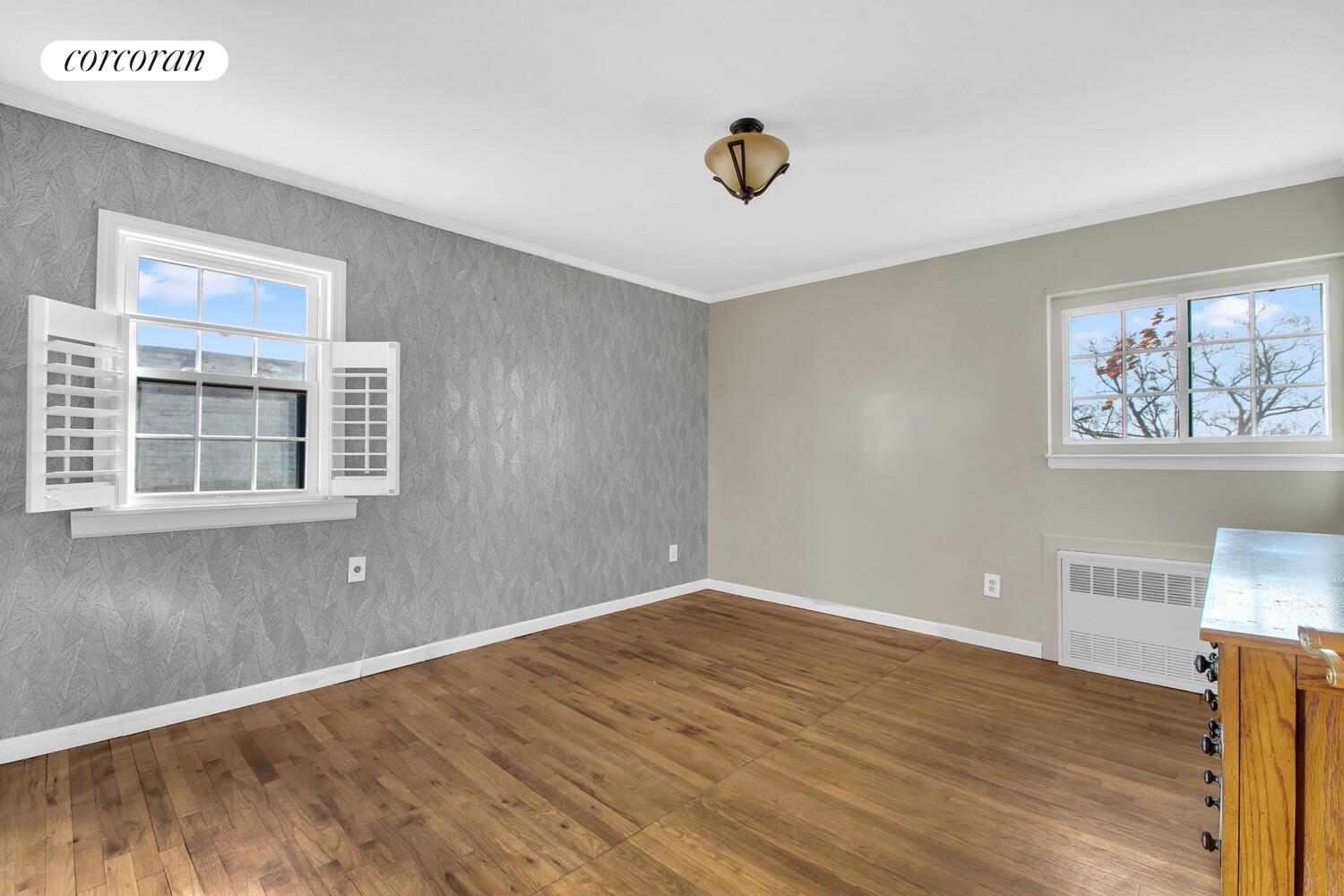 81-22 Haddon Street Queens, NY 11432 - Photo 9 of 13 a view of an empty room with wooden floor and a window