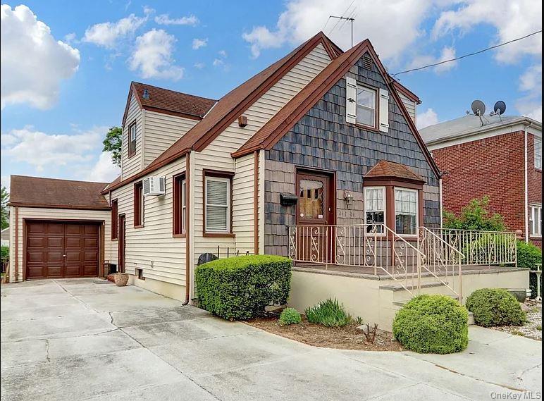 a front view of a house with a yard and potted plants