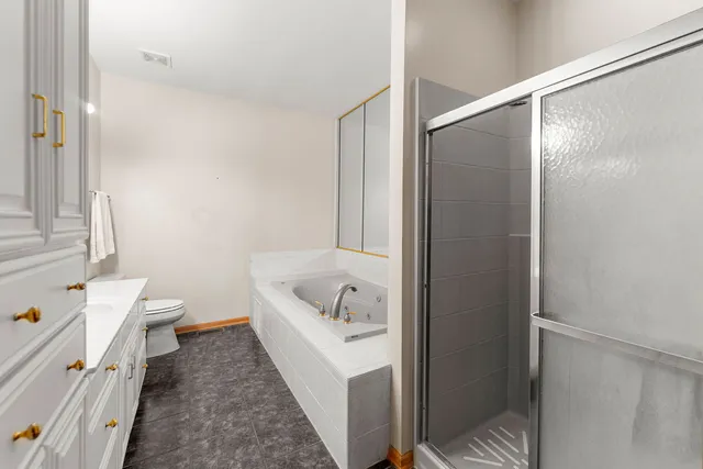 a bathroom with a tub shower and a sink