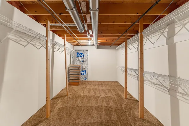 a view of deck with wooden floor and fence next to a large window