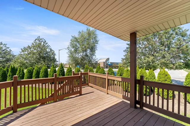 a view of a balcony with two chairs and wooden floor