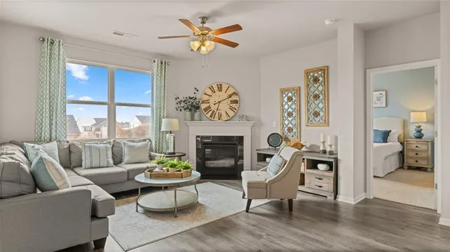a living room with furniture a fireplace and a table