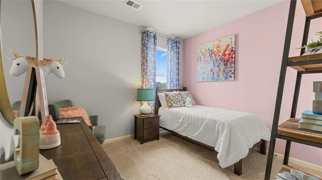 a bedroom with a bed and a desk