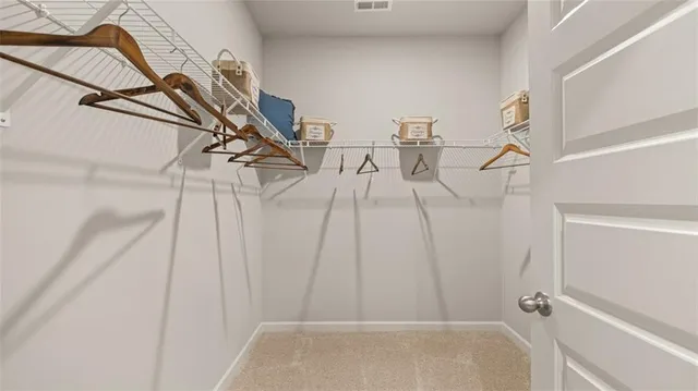 a view of walk in closet with empty racks