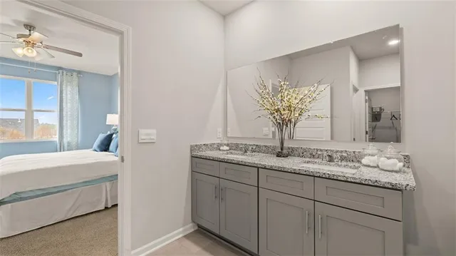a bathroom with a granite countertop sink and a mirror