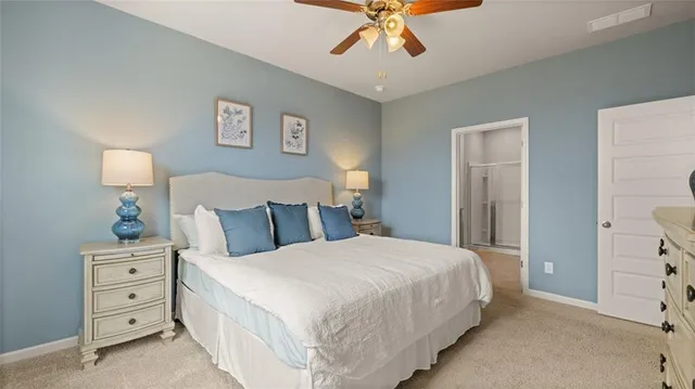 a bedroom with a bed a chandelier and dresser