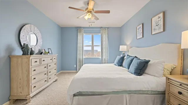 a bedroom with a large bed and a window