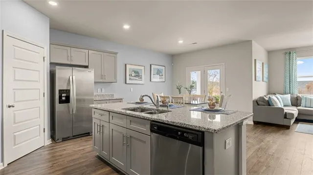 a kitchen with refrigerator and cabinets