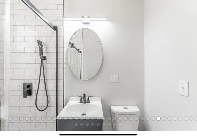 a bathroom with a sink mirror and toilet