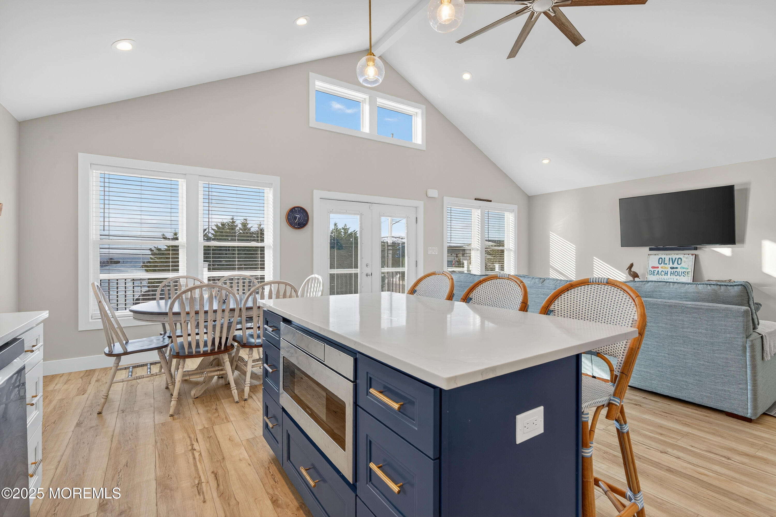 A3255 Goa Way Lavallette, NJ 08735 - Photo 11 of 34 a dining room with a table chairs and a wooden floor