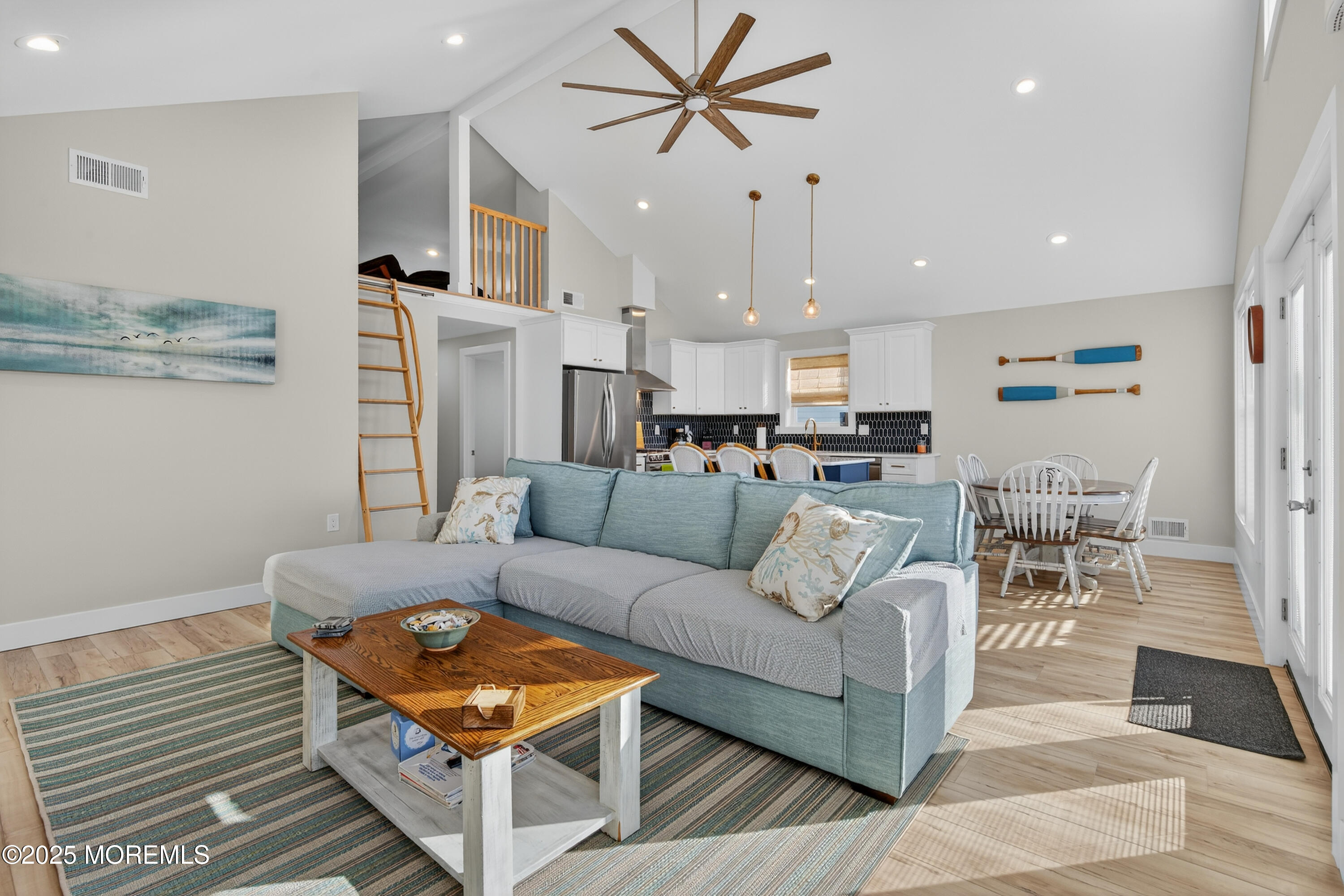 A3255 Goa Way Lavallette, NJ 08735 - Photo 12 of 34 a living room with furniture kitchen view and a chandelier
