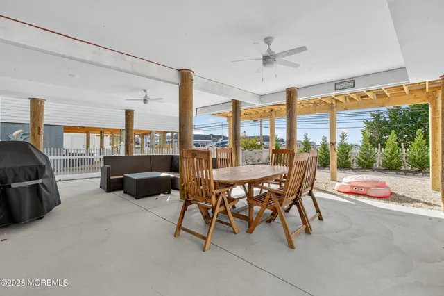 a dining room with furniture and a floor to ceiling window