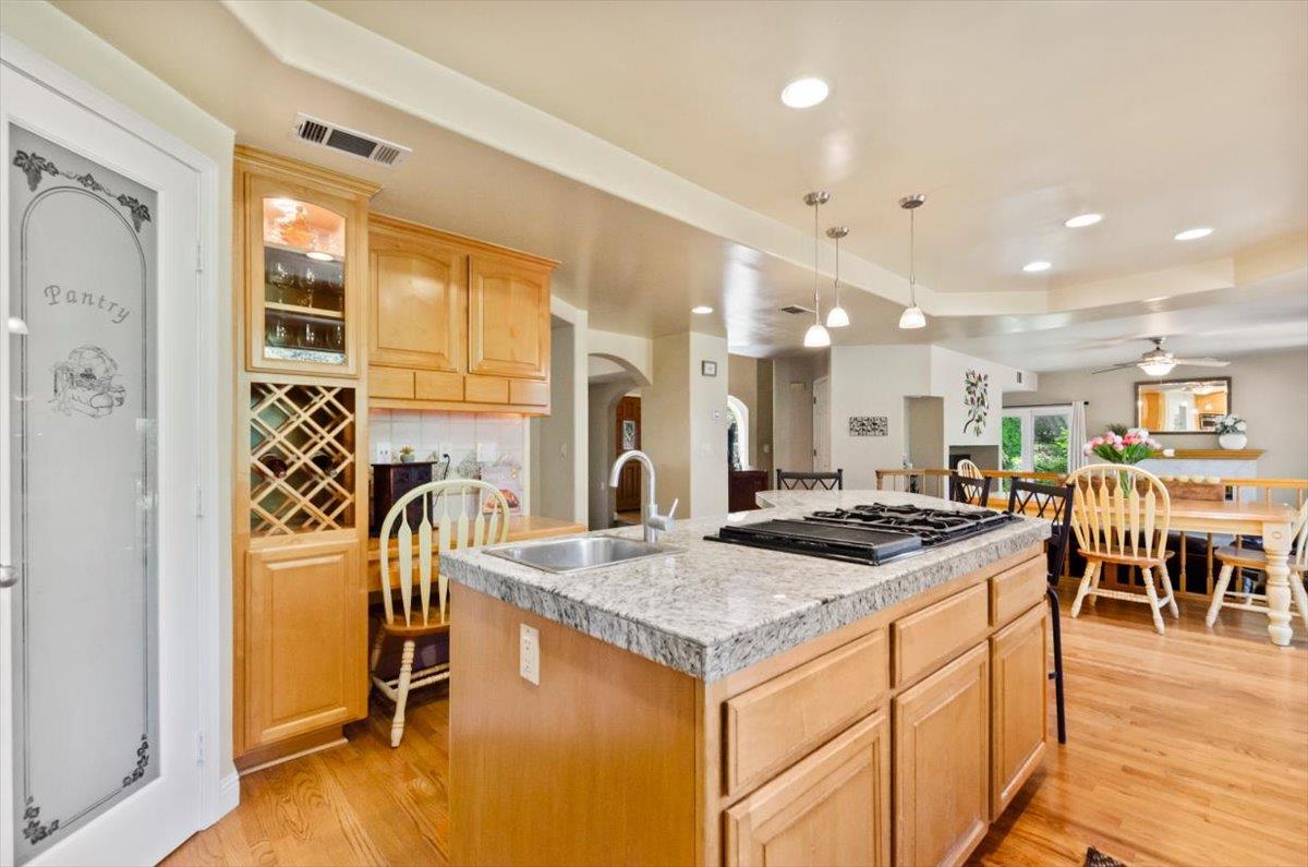 3720 Four Springs Drive Rescue, CA 95672 - Photo 7 of 34 a kitchen with stainless steel appliances granite countertop dining table chairs and a refrigerator