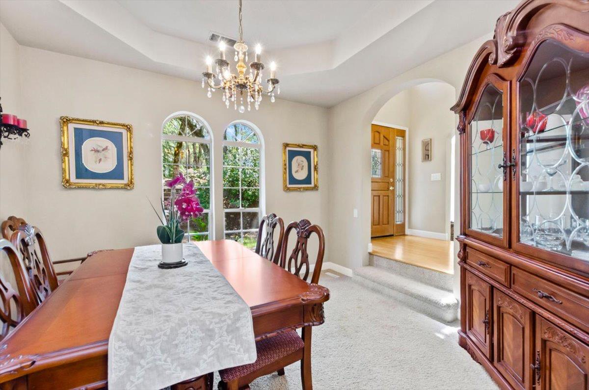 3720 Four Springs Drive Rescue, CA 95672 - Photo 8 of 34 a view of a dining room with furniture and a chandelier