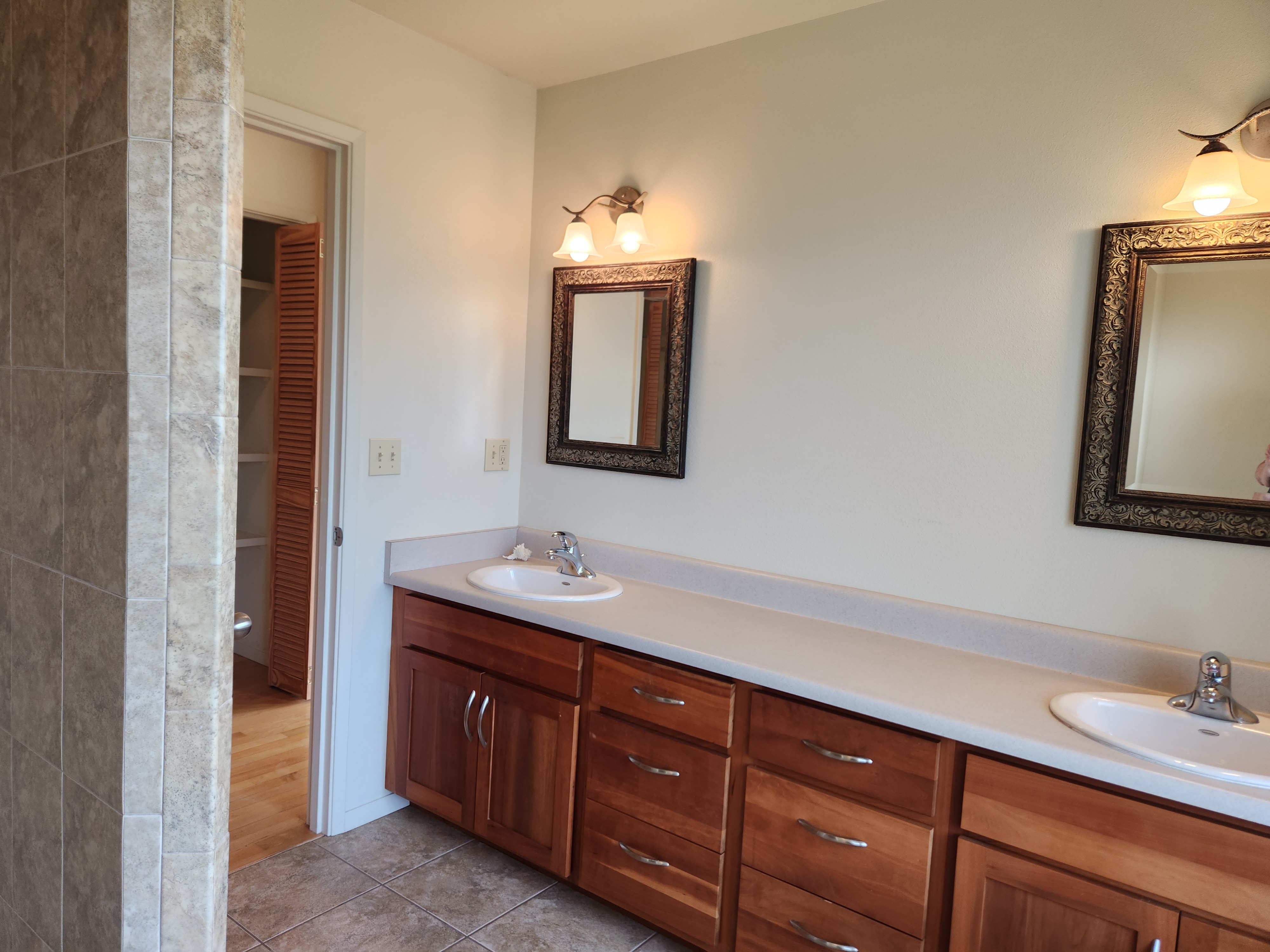 15-974 Lemiwai Road Keaau, HI 96749 - Photo 11 of 30 a bathroom with a double vanity sink and mirror