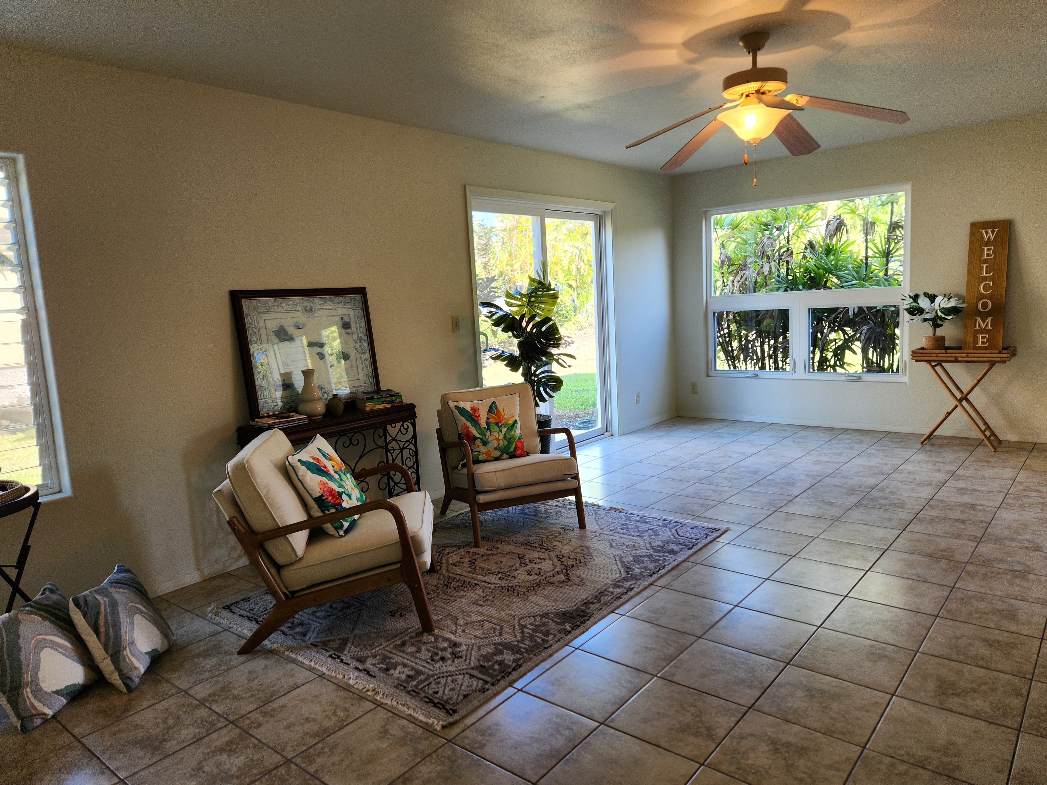 15-974 Lemiwai Road Keaau, HI 96749 - Photo 20 of 30 a living room with furniture and a floor to ceiling window