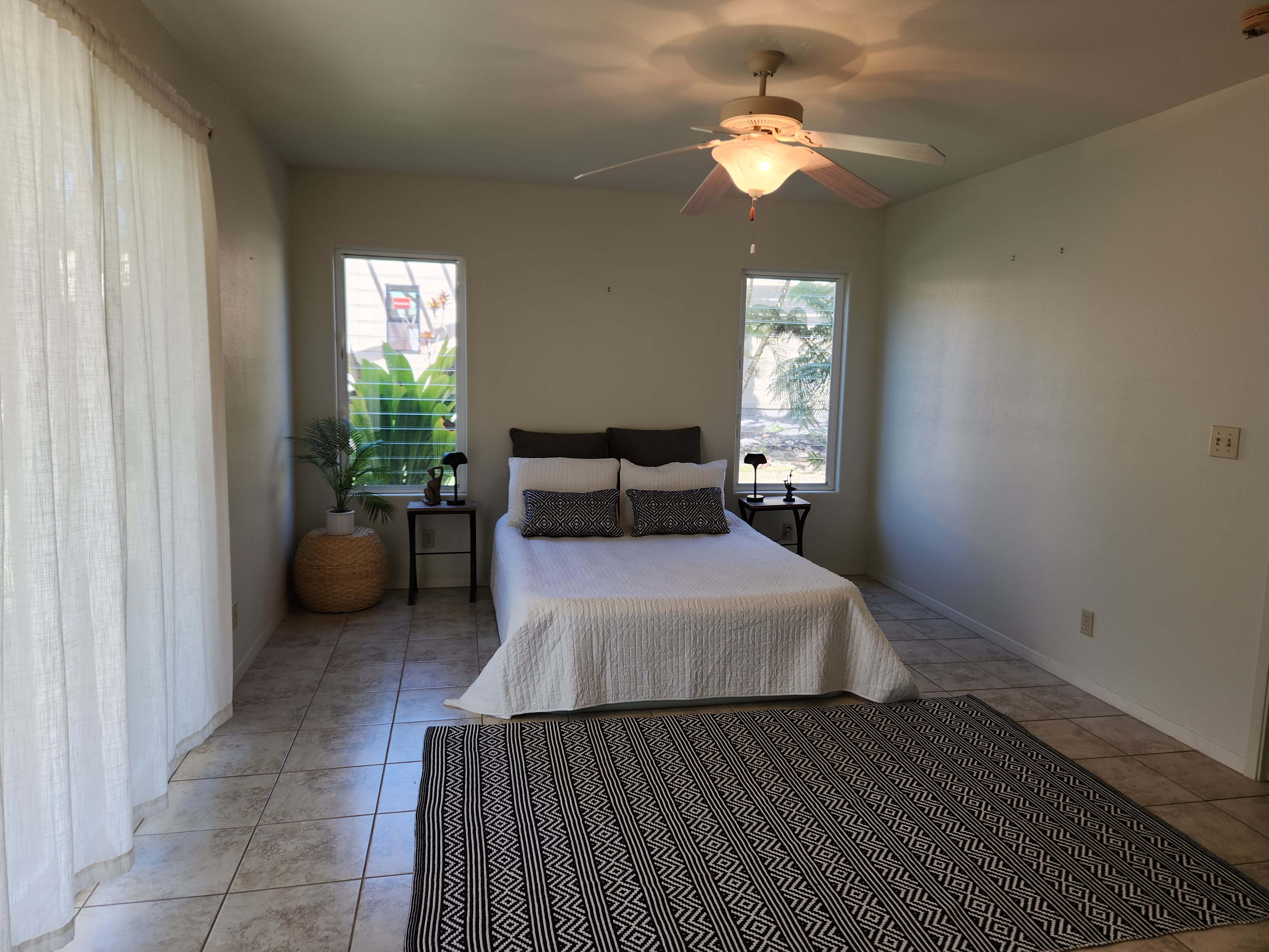 15-974 Lemiwai Road Keaau, HI 96749 - Photo 22 of 30 a bedroom with a bed and a chandelier