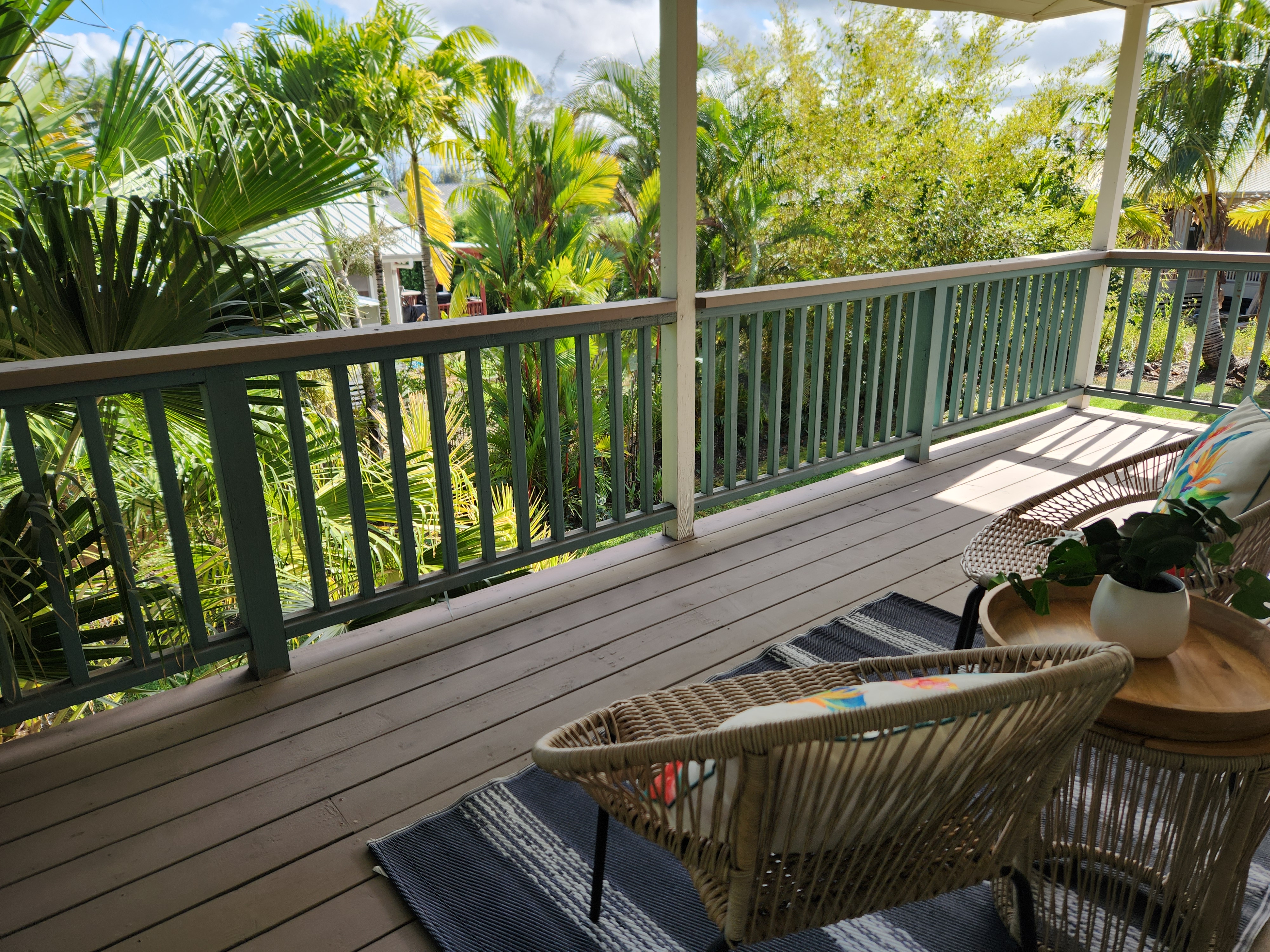 15-974 Lemiwai Road Keaau, HI 96749 - Photo 29 of 30 a balcony with wooden floor table and chairs