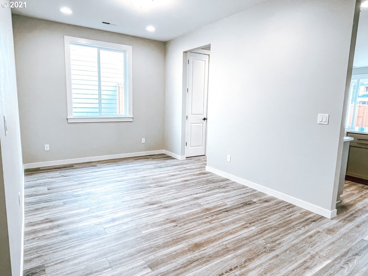 2917 North Mccanta Way Ridgefield, WA 98642 - Photo 4 of 22 an empty room with wooden floor and windows