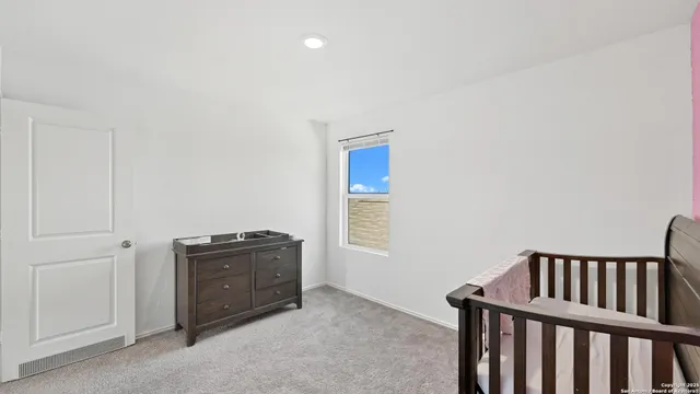 a room with a dresser and a window