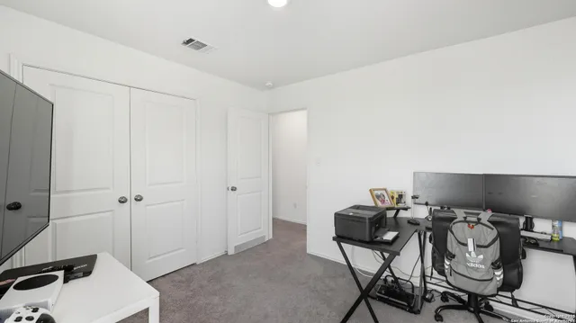 a view of a workspace with furniture and wooden floor