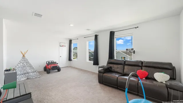 a living room with furniture chess board and couch
