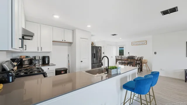 a kitchen with stainless steel appliances kitchen island granite countertop a sink and cabinets