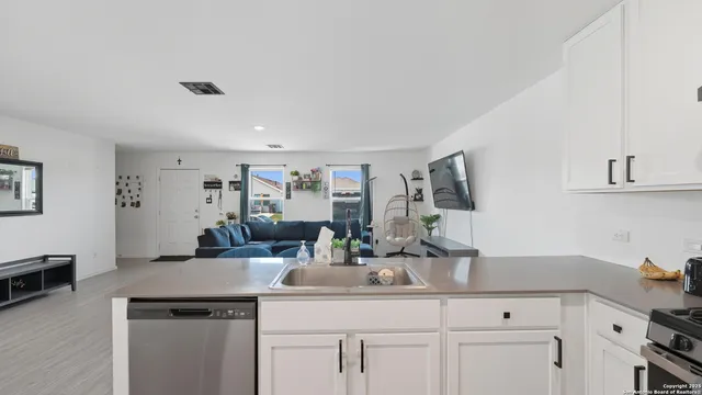 a kitchen with a sink and cabinets