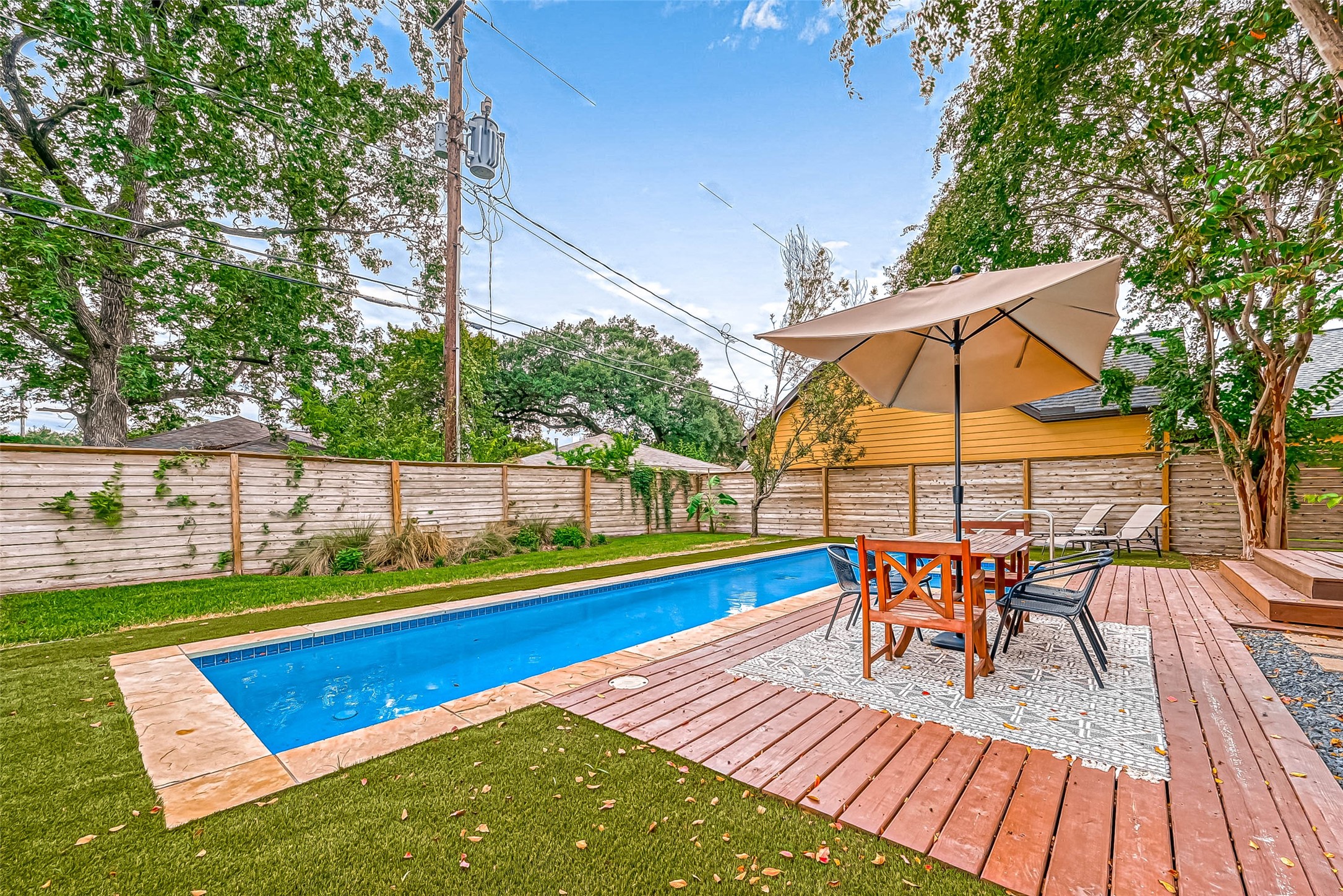412 Sue Street Houston, TX 77009 - Photo 18 of 19 Side view of backyard capturing outdoor seating with pool in background.