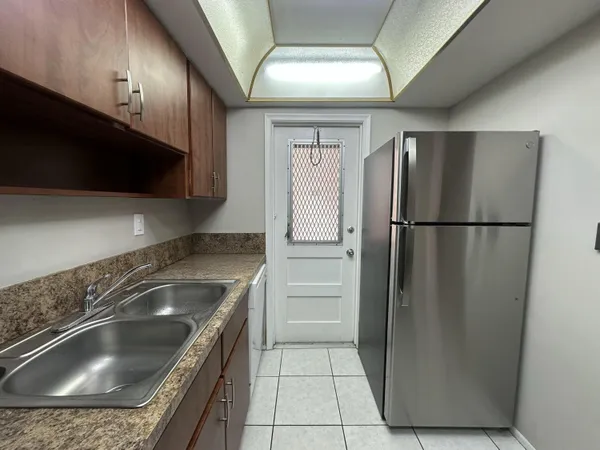 a kitchen with a refrigerator and a sink