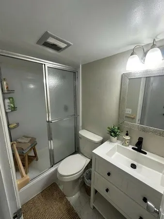 a bathroom with a toilet sink and shower