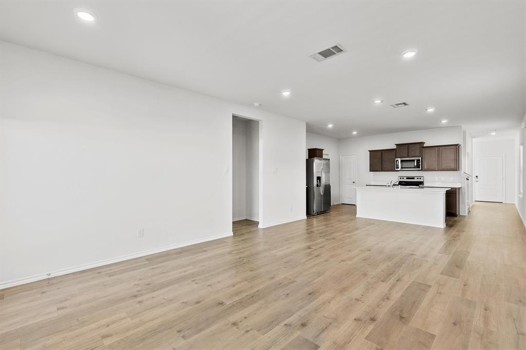 809 Trough Street Royse City, TX 75189 - Photo 11 of 38 a view of a kitchen with a sink and a refrigerator