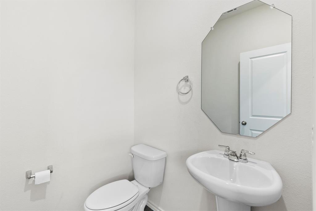 809 Trough Street Royse City, TX 75189 - Photo 26 of 38 a bathroom with a sink mirror and toilet