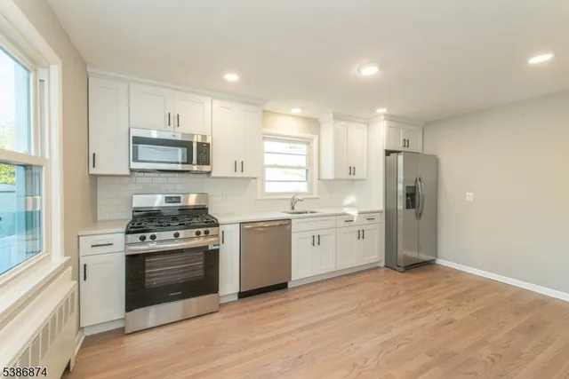 a kitchen with a stove a sink and a refrigerator