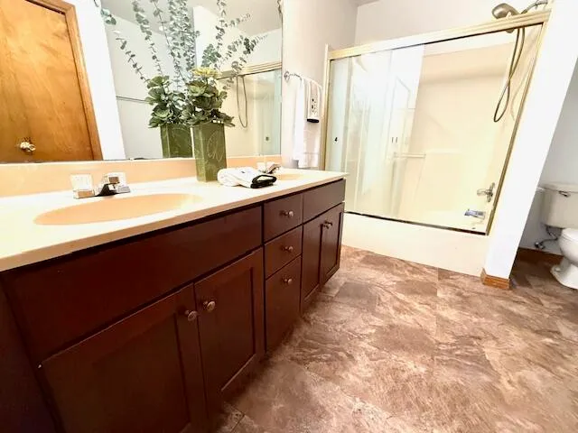 a spacious bathroom with a double vanity sink and a mirror