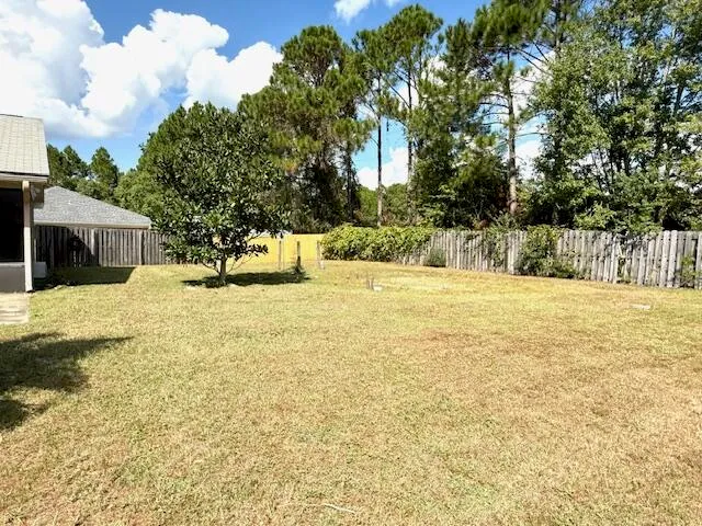 a swimming pool with outdoor seating and yard