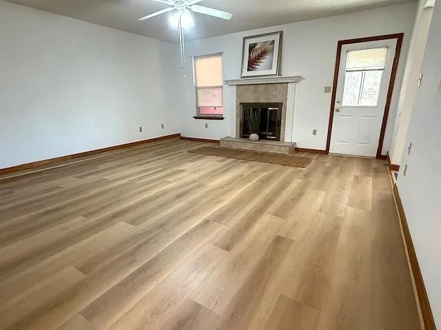 a view of empty room with window and fireplace