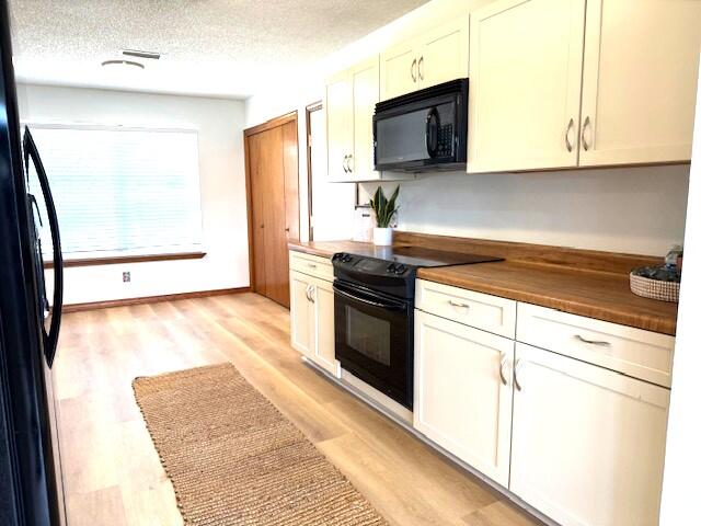 2252 Prytania Circle Navarre, FL 32566 - Photo 9 of 26 a kitchen with stainless steel appliances white cabinets and a stove top oven