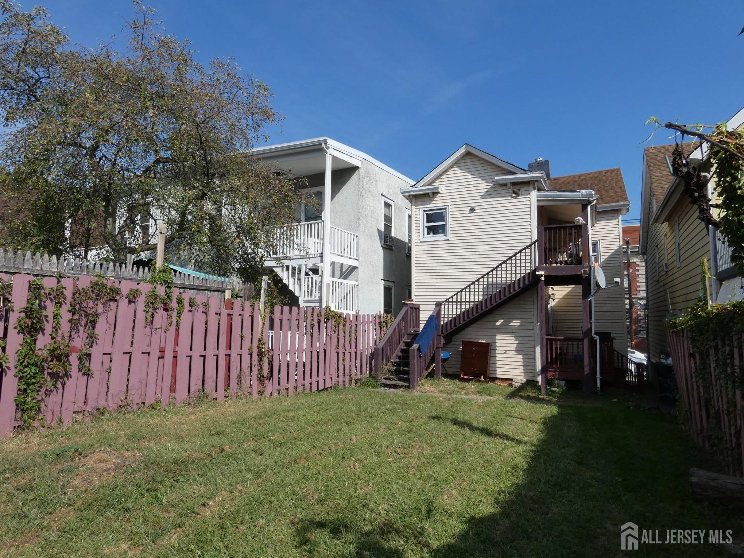 355 High Street Perth Amboy, NJ 08861 - Photo 17 of 19 a view of a house with wooden fence and a yard
