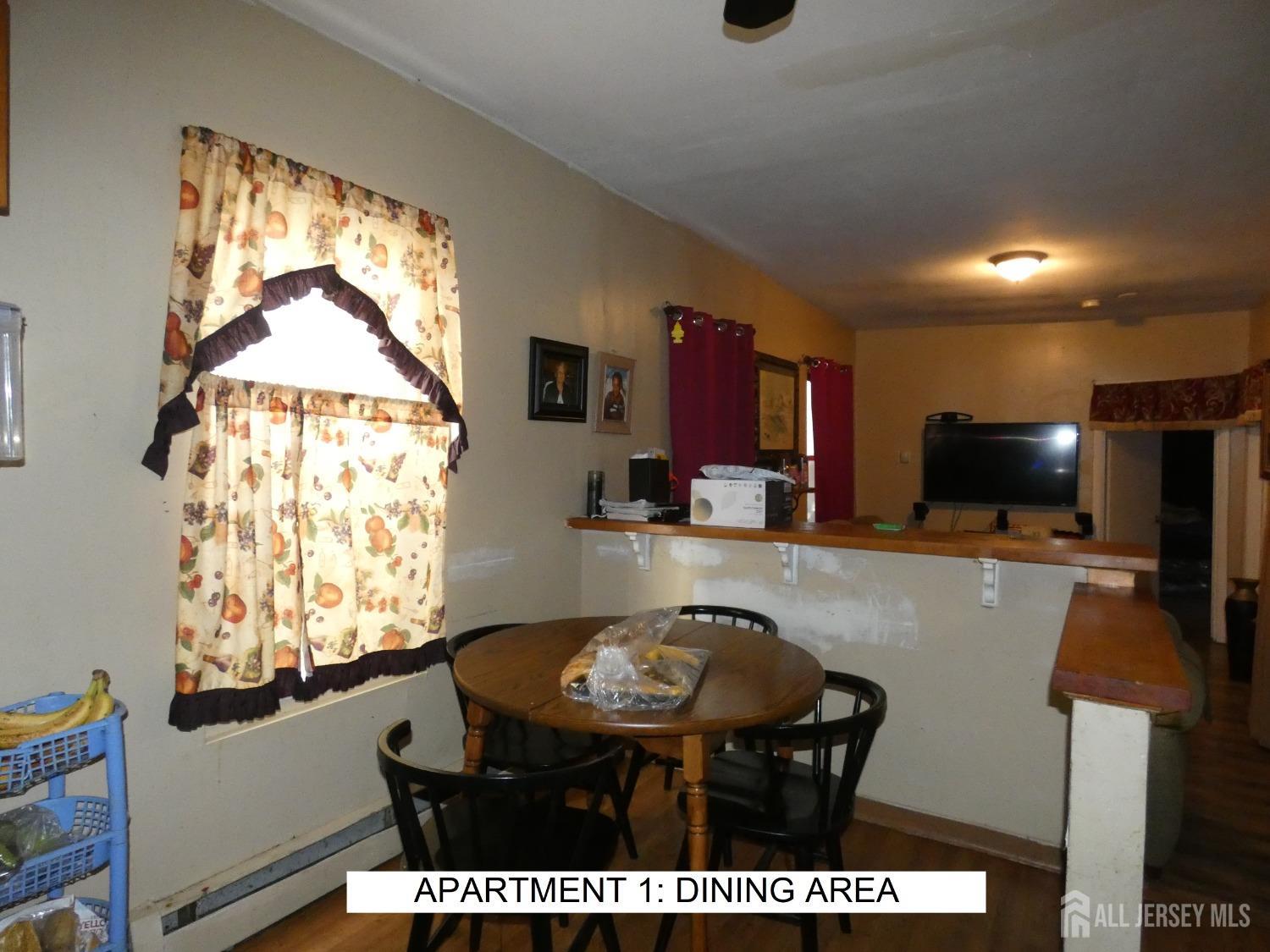 355 High Street Perth Amboy, NJ 08861 - Photo 3 of 19 a living room with furniture a flat screen tv and a large window