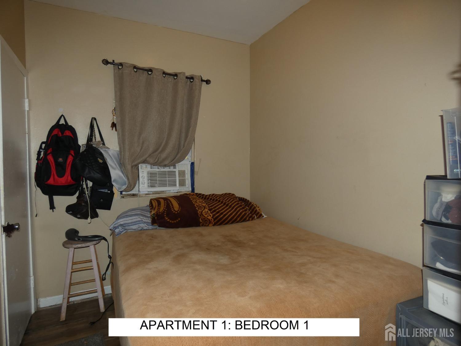 355 High Street Perth Amboy, NJ 08861 - Photo 5 of 19 a bedroom with a bed and a closet