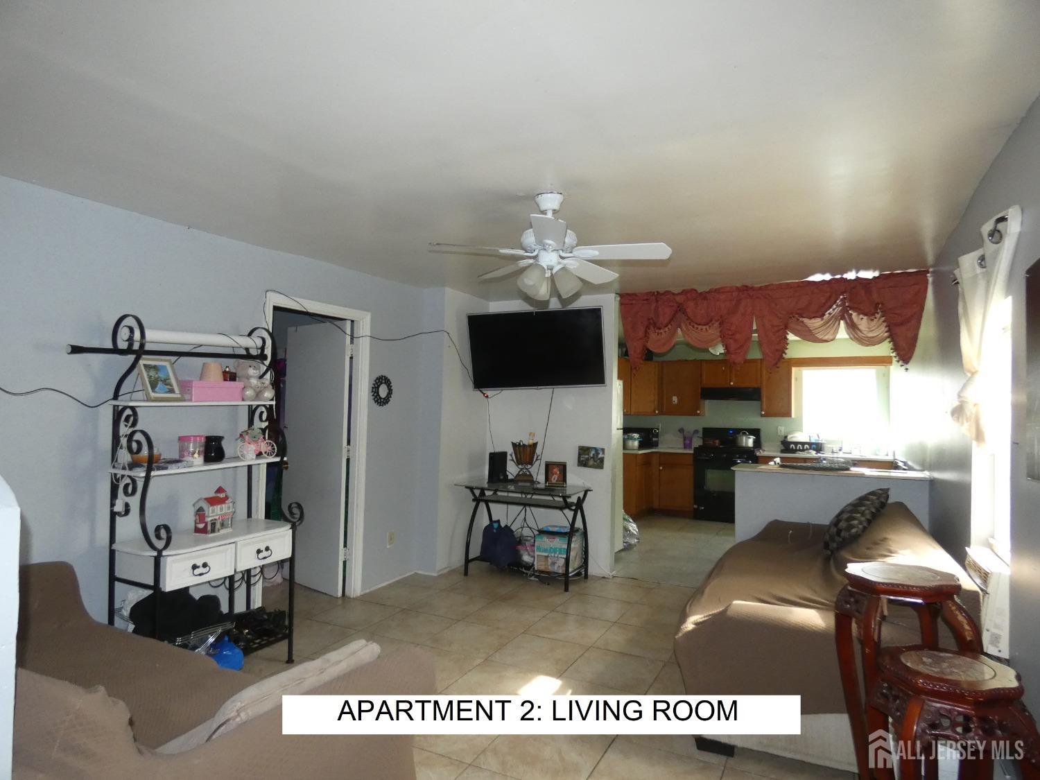 355 High Street Perth Amboy, NJ 08861 - Photo 7 of 19 a living room with furniture and a flat screen tv